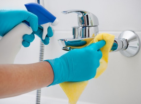 Professional cleaner wiping kitchen surfaces during move in cleaning
