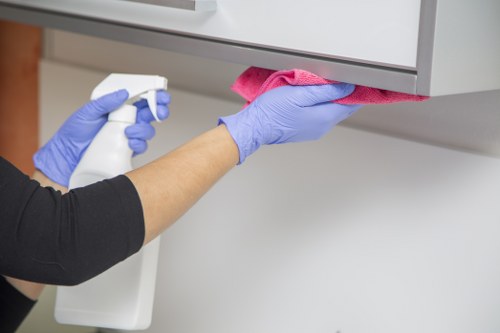 Professional office cleaning service sanitizing workstations